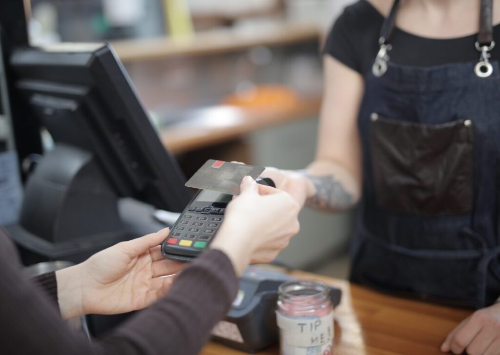 Person paying with credit card at the counter.