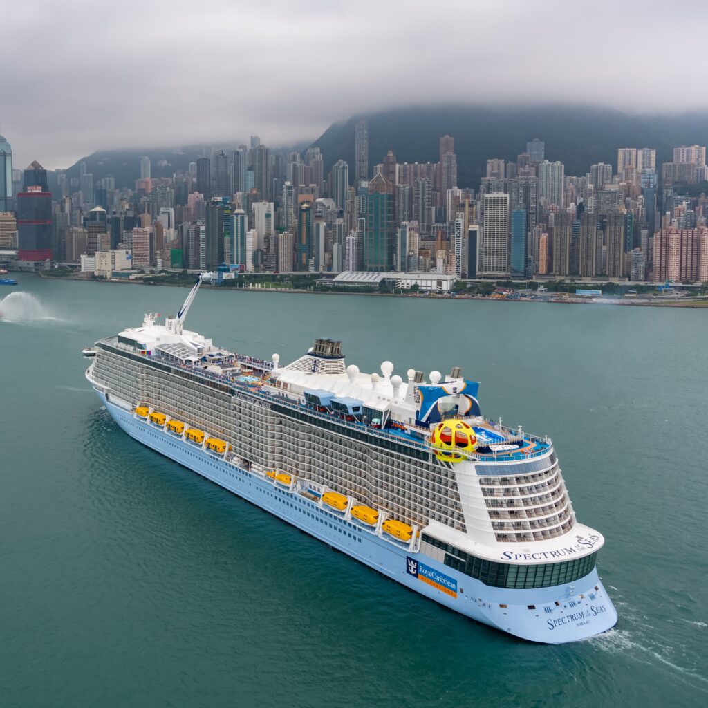 View of Spectrum of the Seas sailing with city on the background.