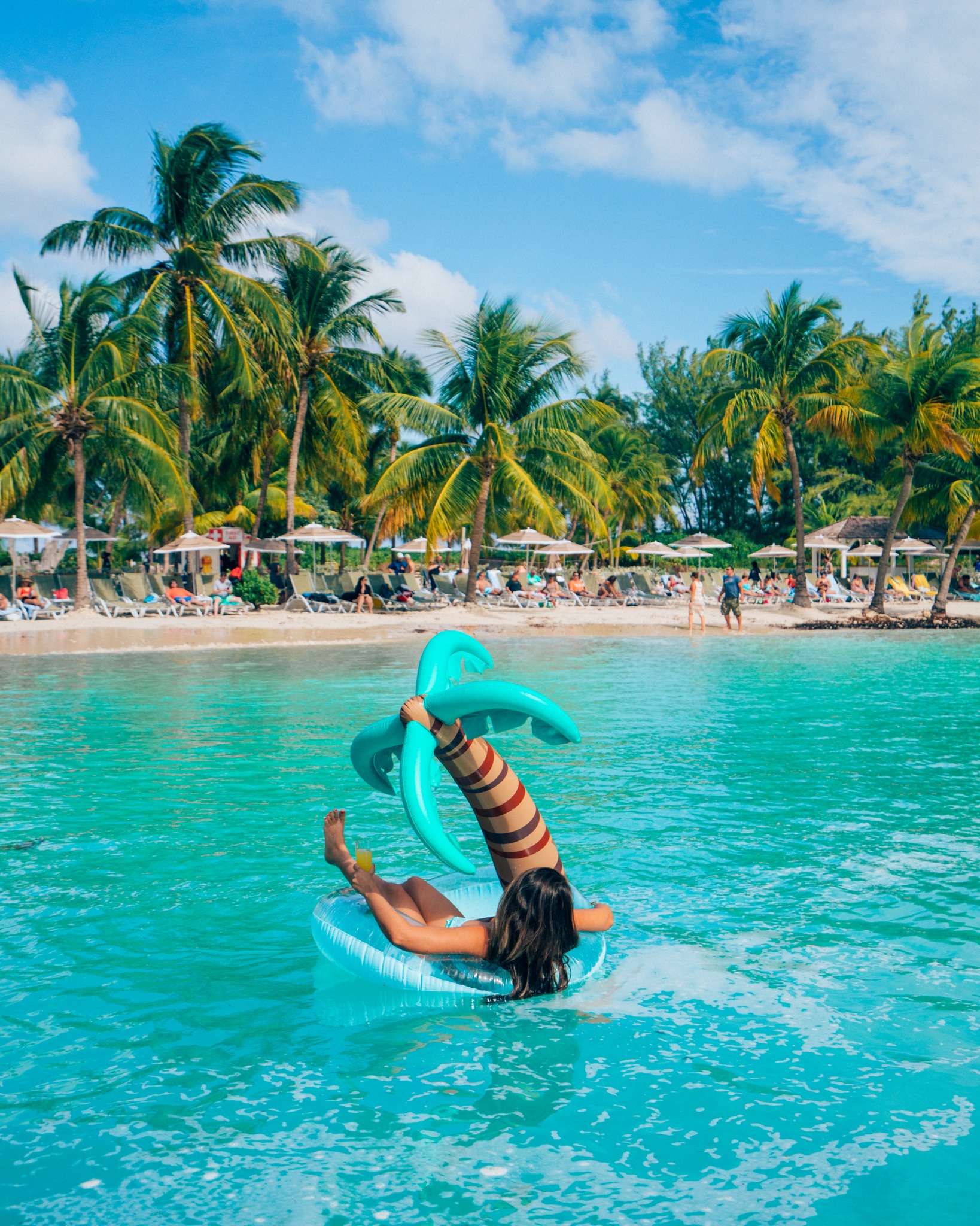 View of Nassau, Bahamas beach with woman in an inflatable ring.