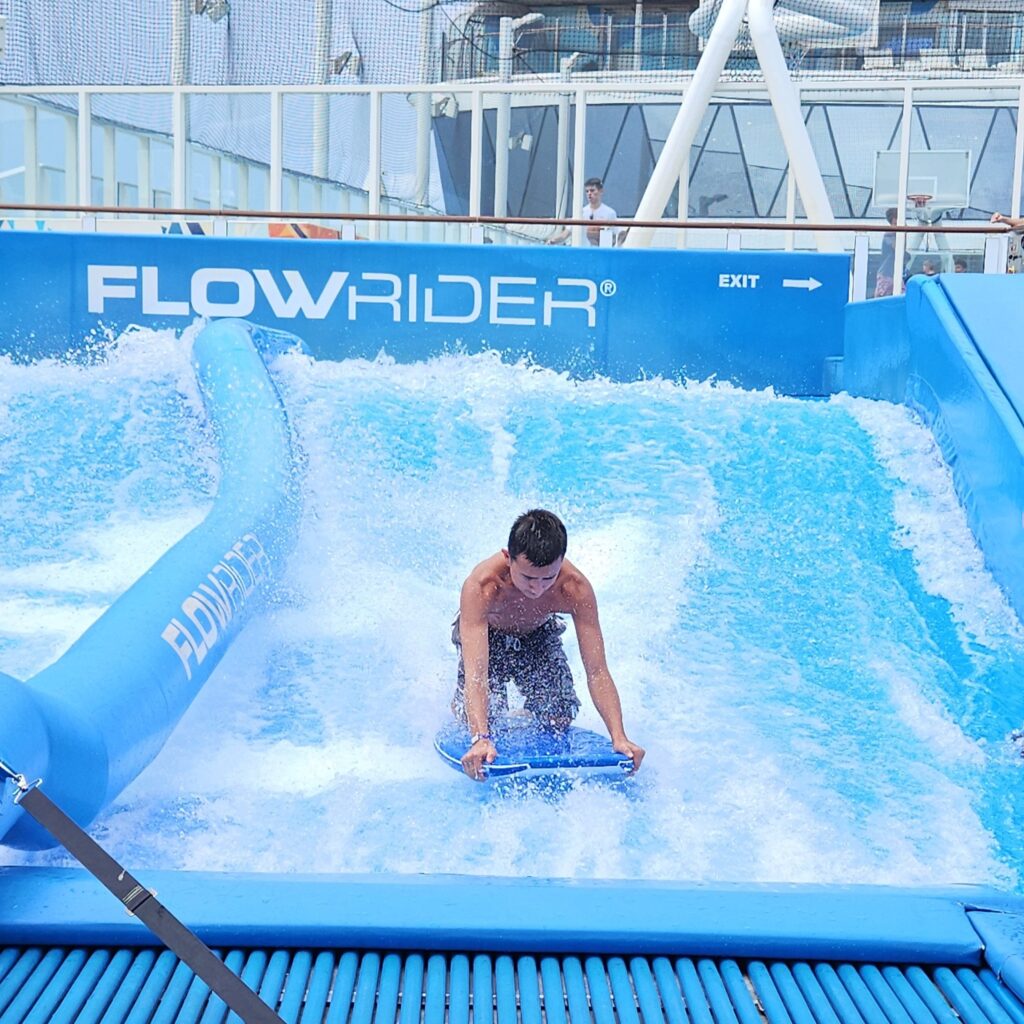 Boy on the FlowRider surfing simulator.