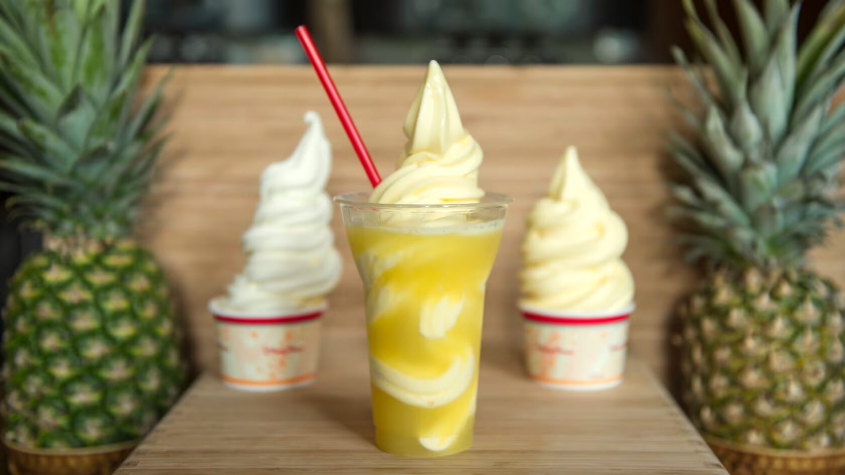 Cups of Dole whip soft serve and float on a table.