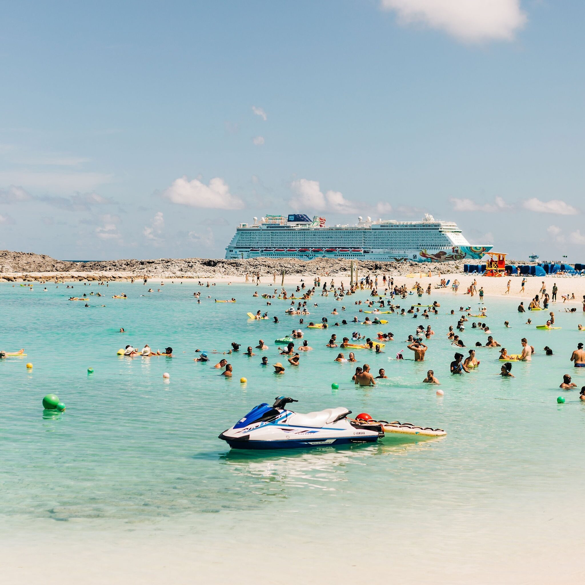 Jetski and crowd swimming on the beach at Great Stirrup Cay, Norwegian Cruise Line's private island.